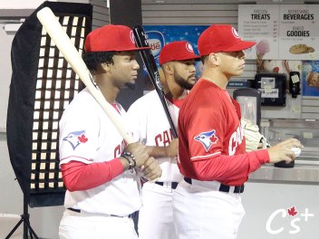 Sterling Guzman and Jesus Navarro wield the bats behind pitcher Justin Watts.